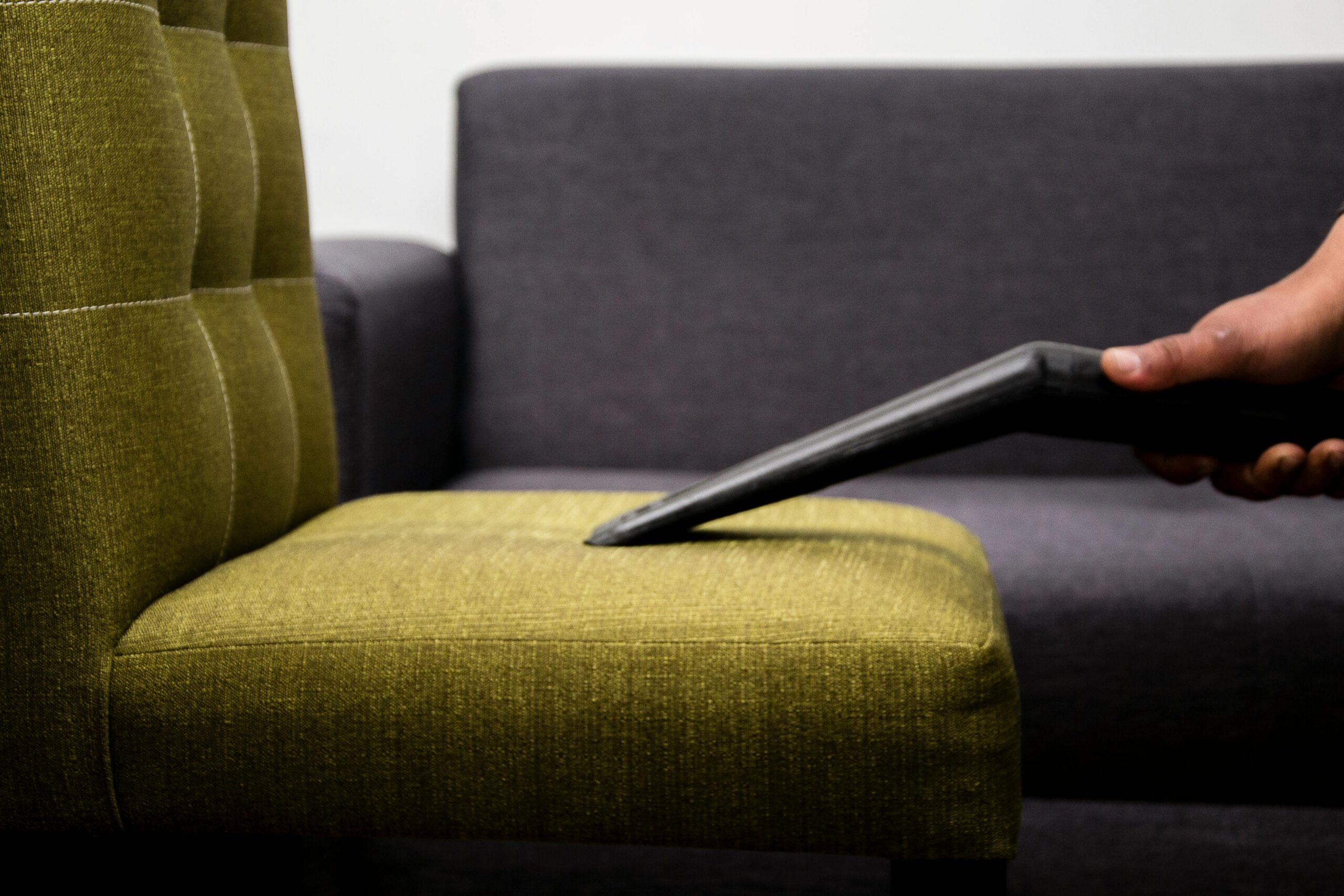 Cleaner Vacuuming a Sofa Chair