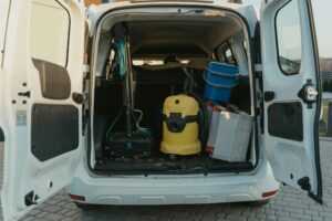 Yellow and Blue Plastic Trash Bin in White Car